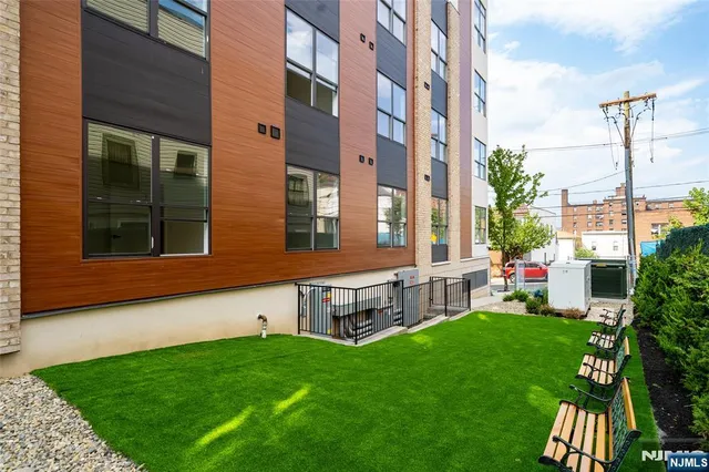 a view of an apartment with a backyard