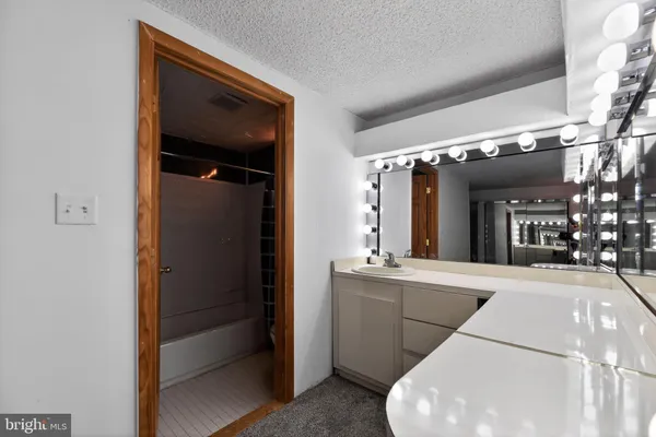 a en suite bathroom with a sink and mirror