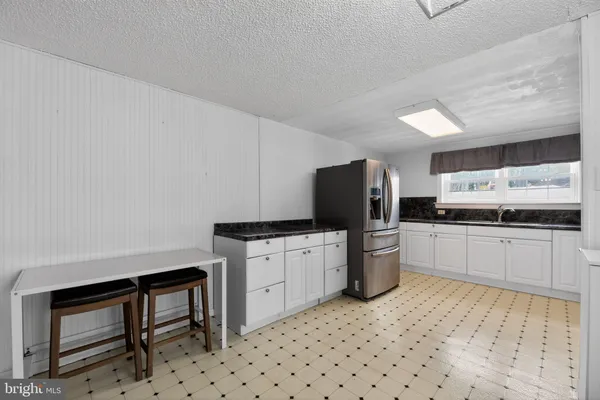 a kitchen with a sink cabinets and stainless steel appliances