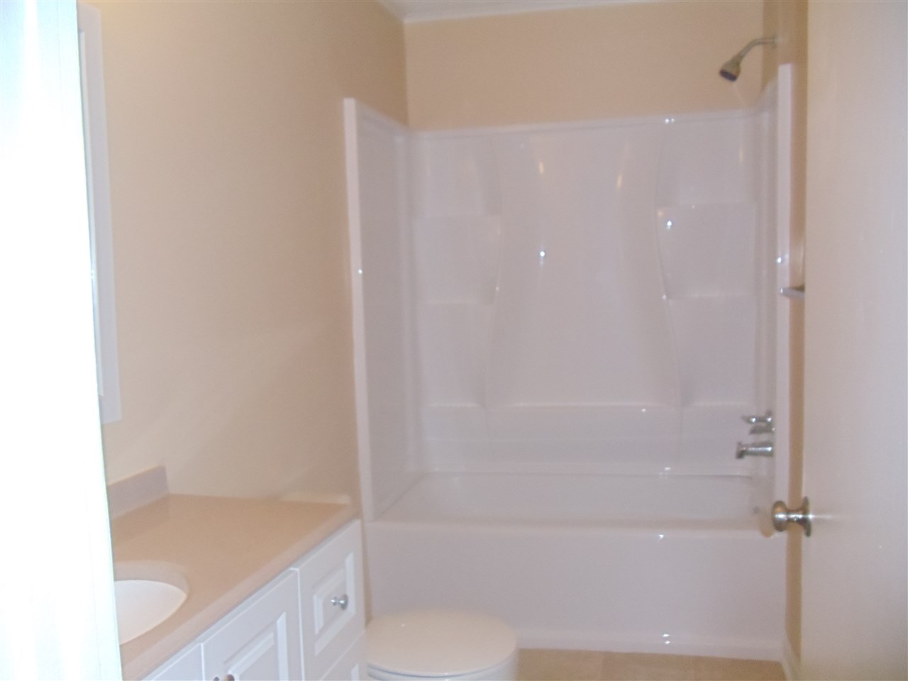 273 North Main Street Ripley, TN 38063 - Photo 12 of 15 a bathroom with a granite countertop sink a toilet and shower