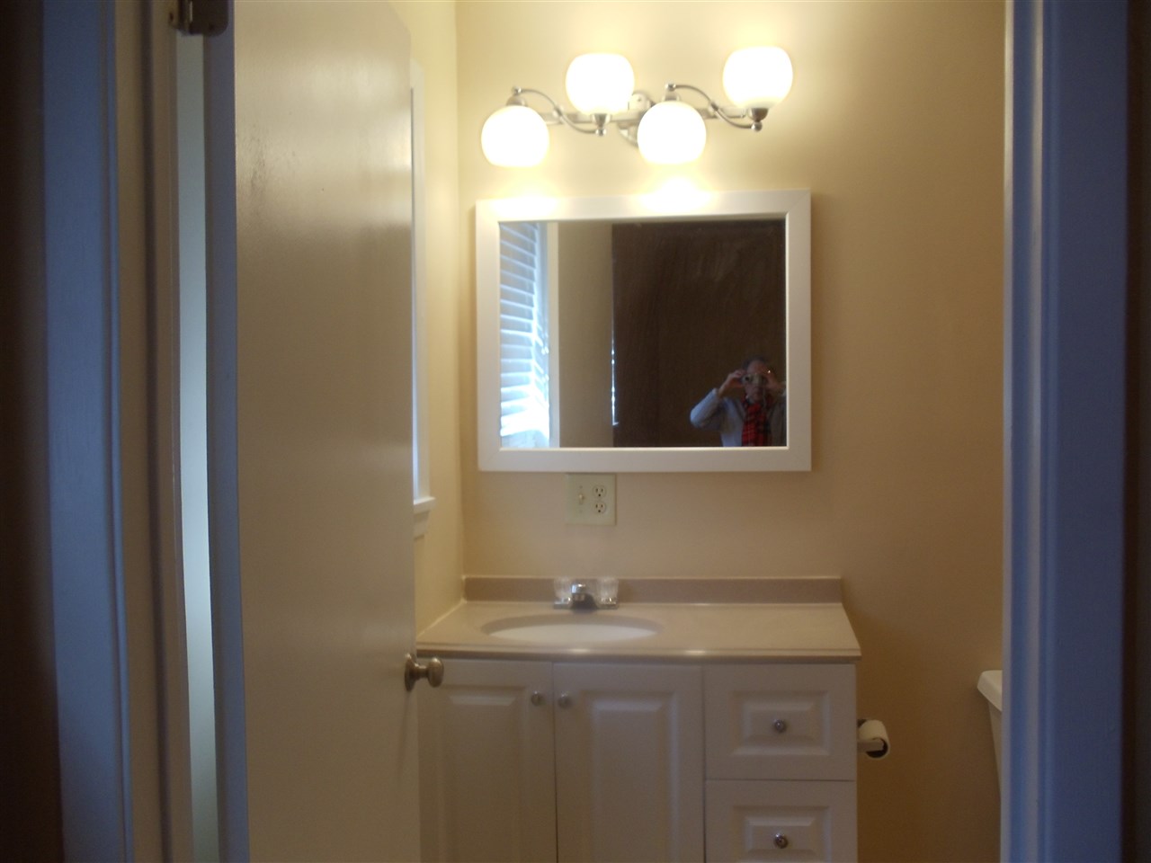 273 North Main Street Ripley, TN 38063 - Photo 8 of 15 a bathroom with a granite countertop sink and a mirror