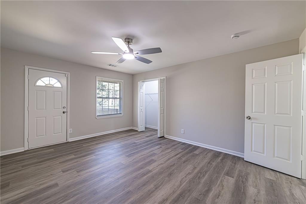 2362 Springrun Court Decatur, GA 30032 - Photo 40 of 83 a view of an empty room with a window and wooden floor