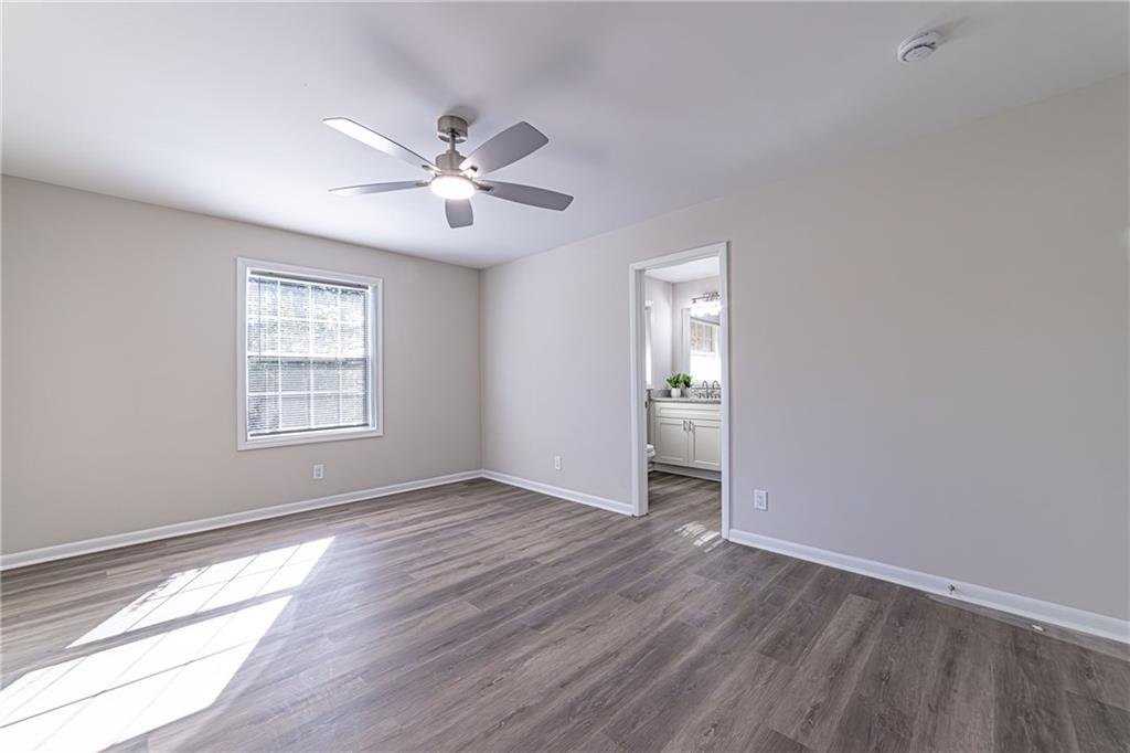 2362 Springrun Court Decatur, GA 30032 - Photo 48 of 83 a view of an empty room with wooden floor and a window