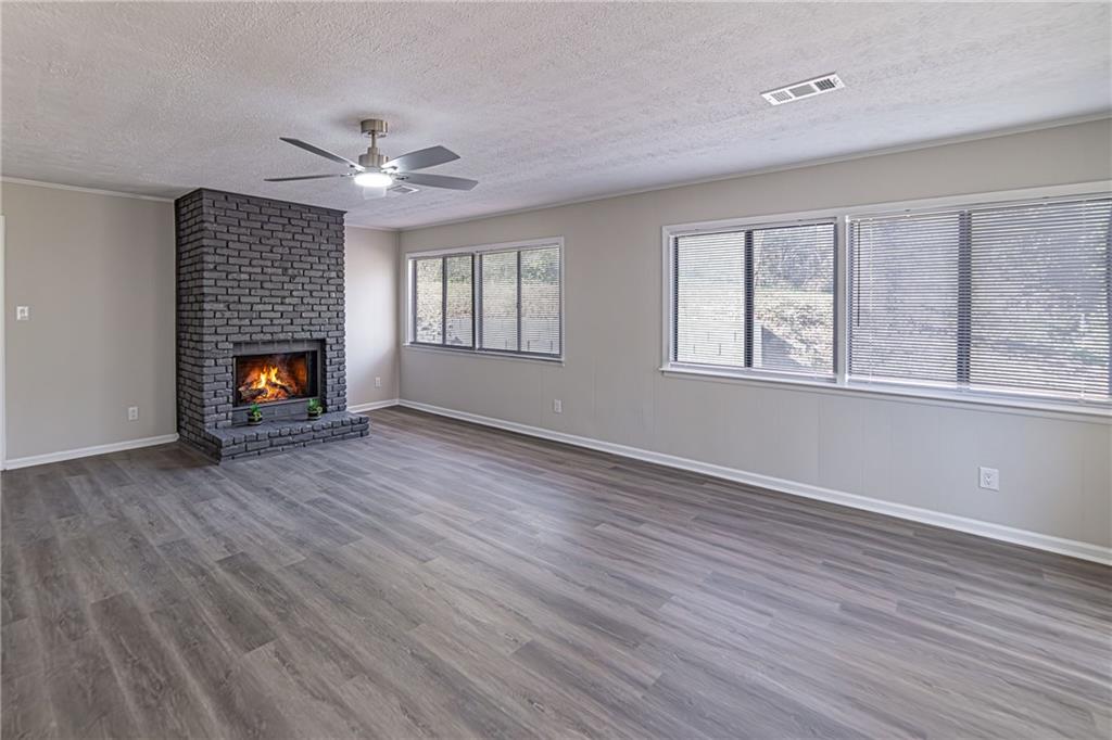 2362 Springrun Court Decatur, GA 30032 - Photo 57 of 83 an empty room with wooden floor fireplace and windows