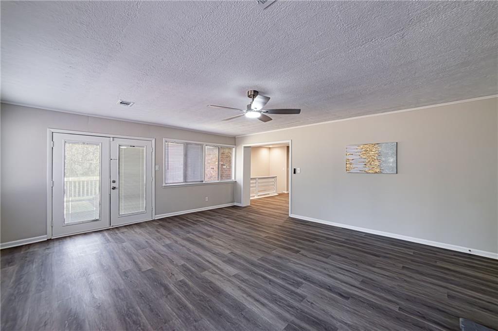 2362 Springrun Court Decatur, GA 30032 - Photo 59 of 83 a view of an empty room with wooden floor and a window