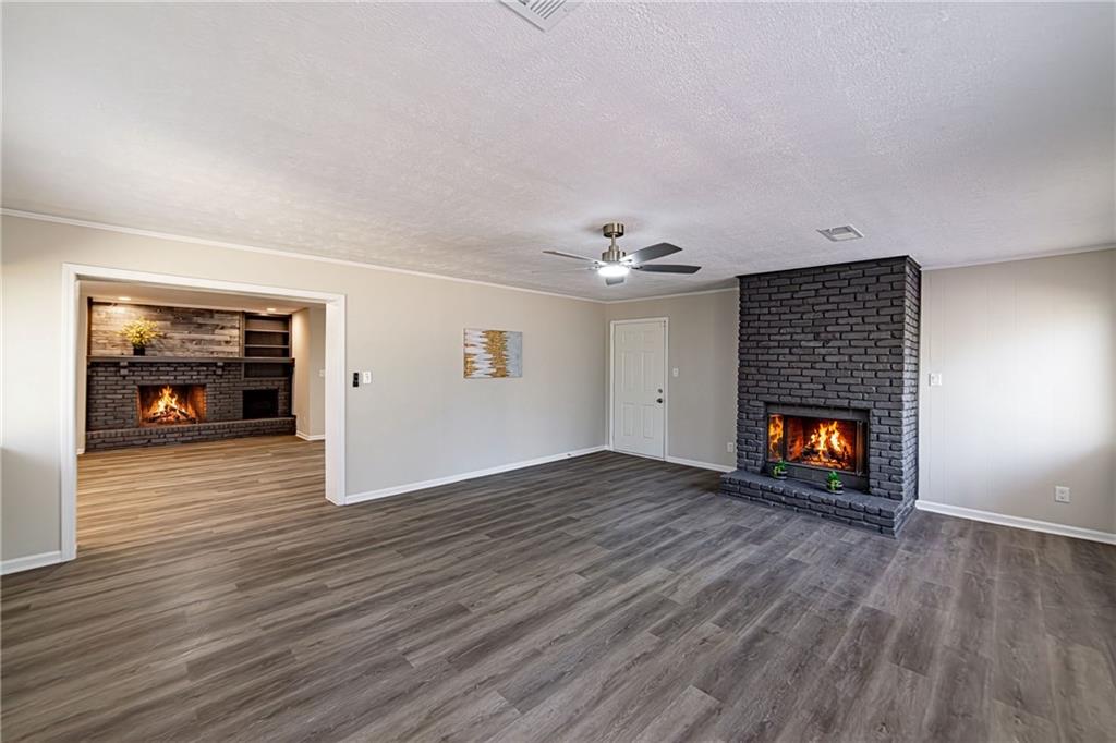 2362 Springrun Court Decatur, GA 30032 - Photo 60 of 83 an empty room with wooden floor fireplace and window