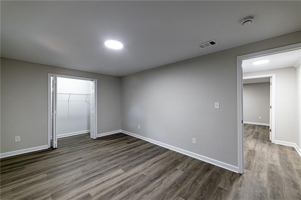 2362 Springrun Court Decatur, GA 30032 - Photo 72 of 83 a view of an empty room with wooden floor and a window