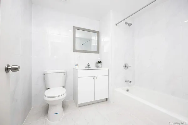 a bathroom with a toilet a sink and bathtub