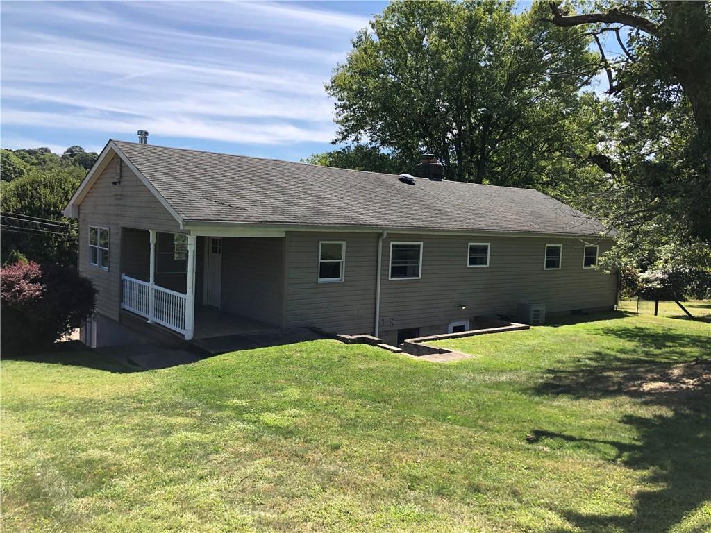 1277 Harrison City Export Road Jeannette, PA 15644 - Photo 11 of 17 a front view of a house with a yard and garage