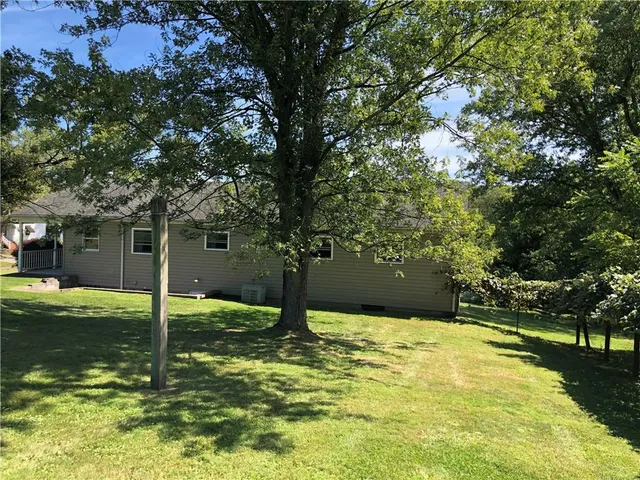 a swimming pool with trees in the background