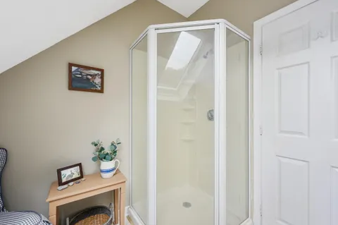 a view of a hallway with furniture and wooden floor
