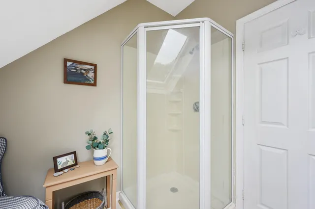 a view of a hallway with furniture and wooden floor