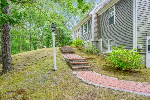 a view of a backyard with chairs