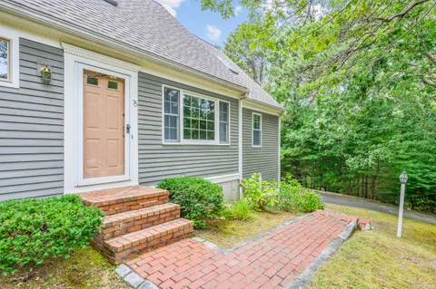 a view of house with backyard and balcony