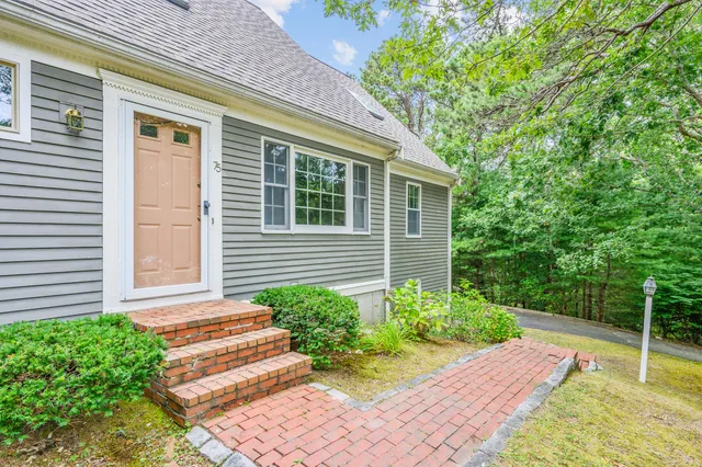 a view of house with backyard and balcony
