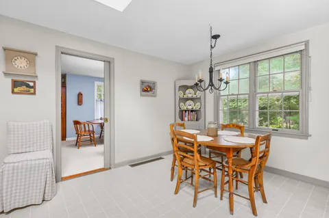 a dining room with furniture window and outside view