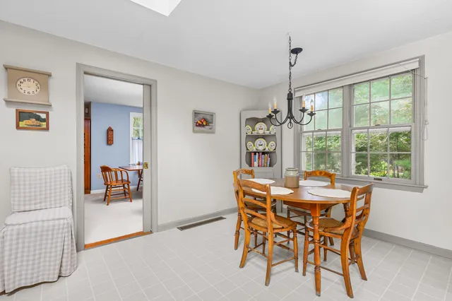a dining room with furniture window and outside view