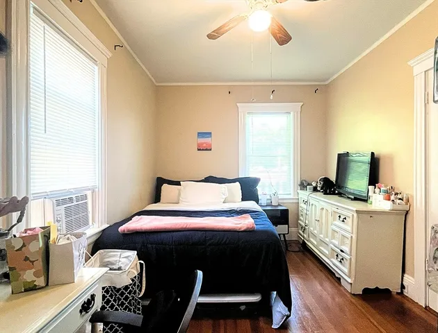 a bedroom with a bed and a tv