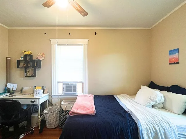 a bedroom with a bed and a window