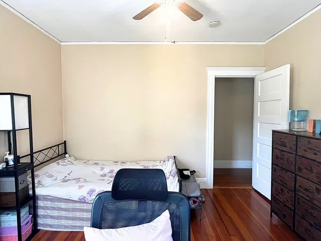 a bedroom with a bed and a mirror