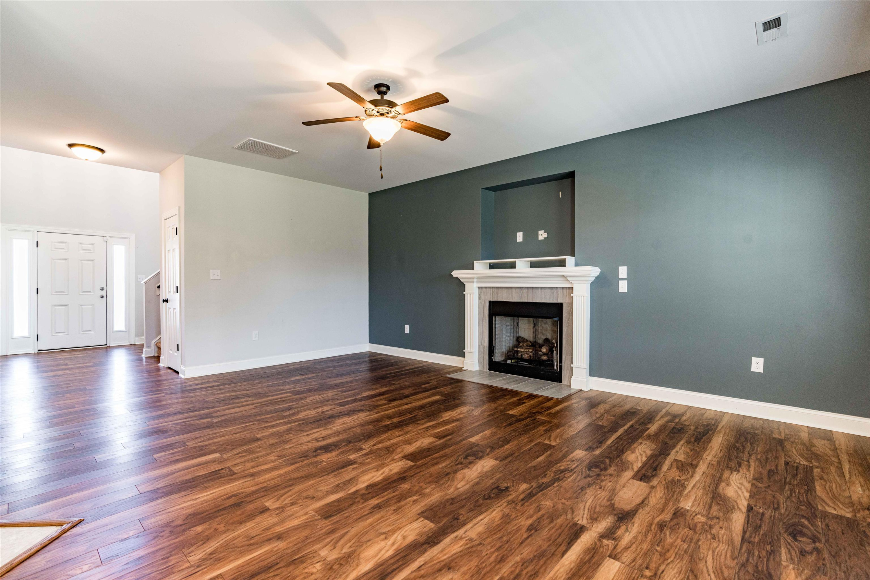 118 Colson Drive Garner, NC 27529 - Photo 12 of 47 a view of an empty room with wooden floor fireplace and a window
