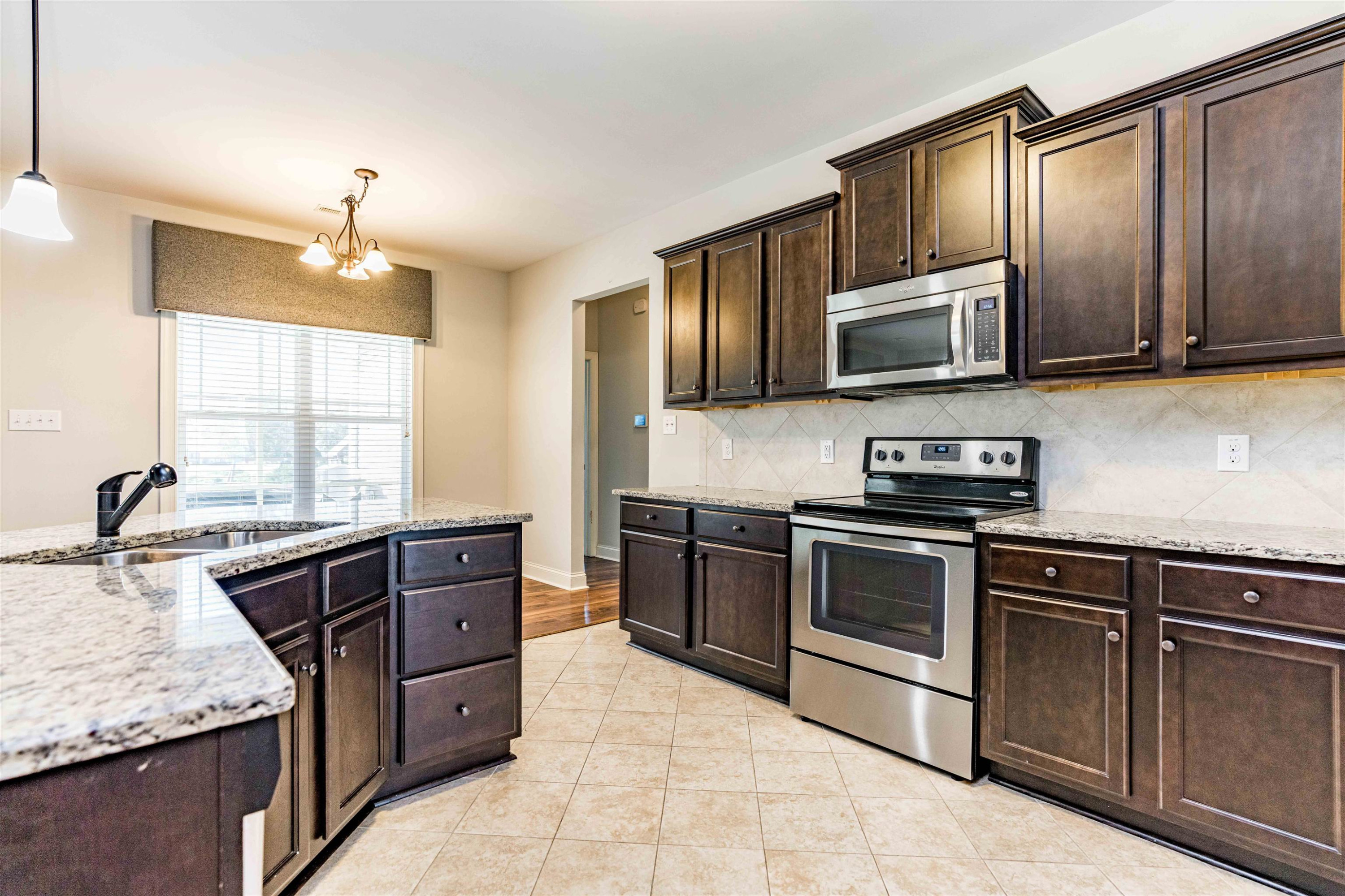 118 Colson Drive Garner, NC 27529 - Photo 15 of 47 a kitchen with stainless steel appliances granite countertop wooden cabinets a stove top oven a sink and dishwasher