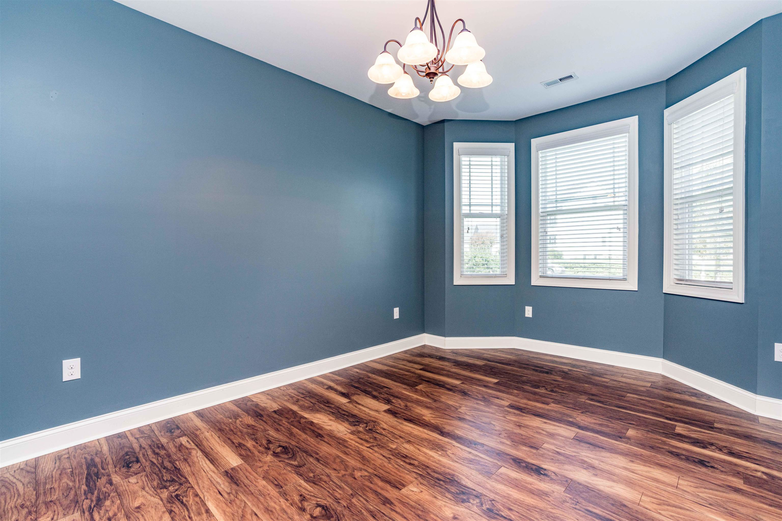 118 Colson Drive Garner, NC 27529 - Photo 20 of 47 a bedroom with a large bed chandelier and a window