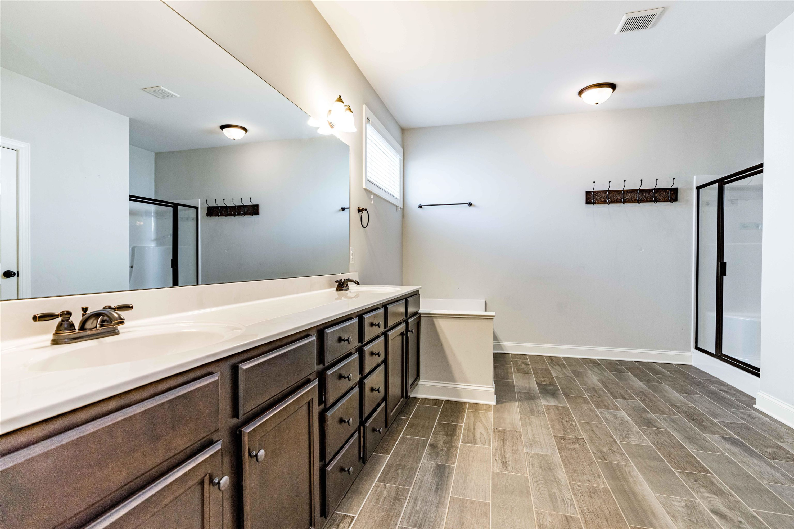 118 Colson Drive Garner, NC 27529 - Photo 26 of 47 a bathroom with a sink a large mirror and a shower