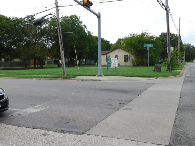 a view of street and small trees