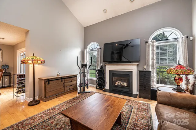 a living room with furniture fireplace and flat screen tv