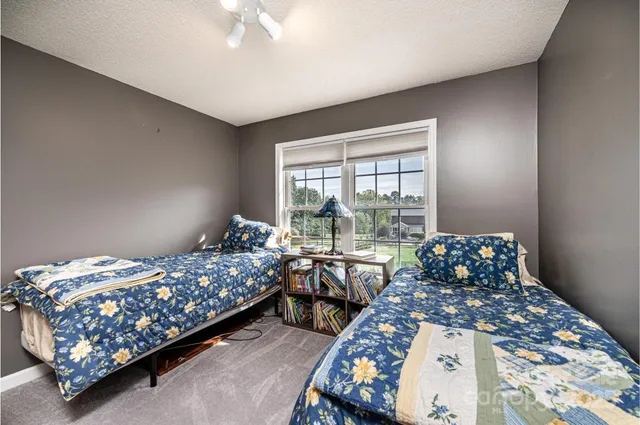 a bedroom with bed and a window