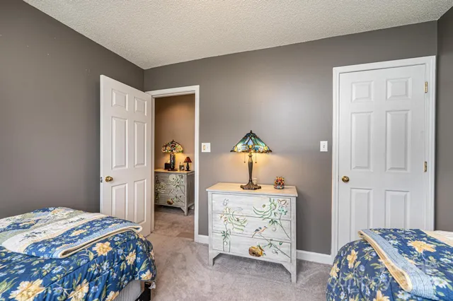 a bedroom with a bed and a dresser in it