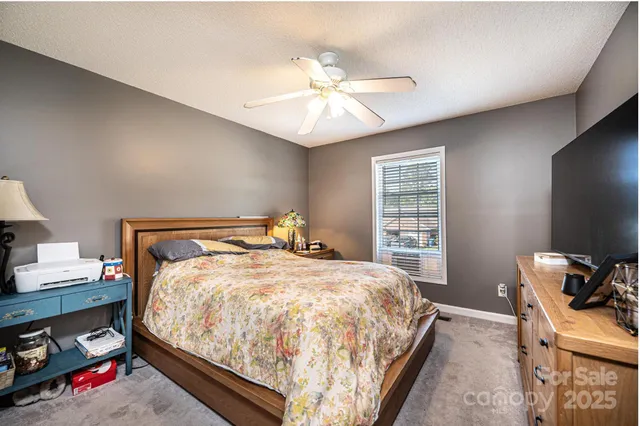 a bed sitting in a bedroom next to a window