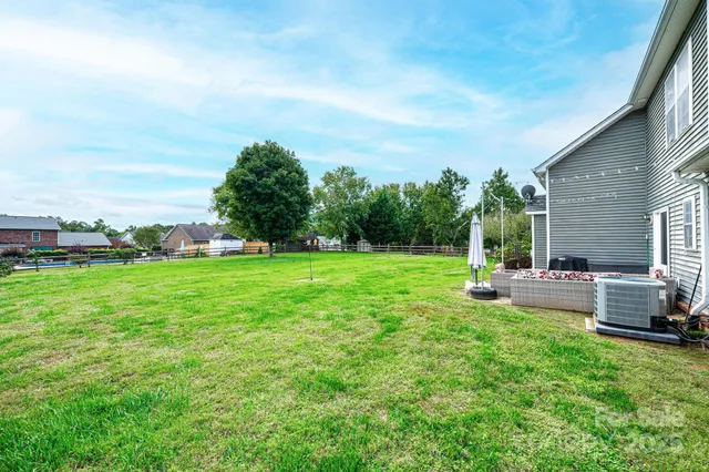 a view of a house with backyard sitting area and garden