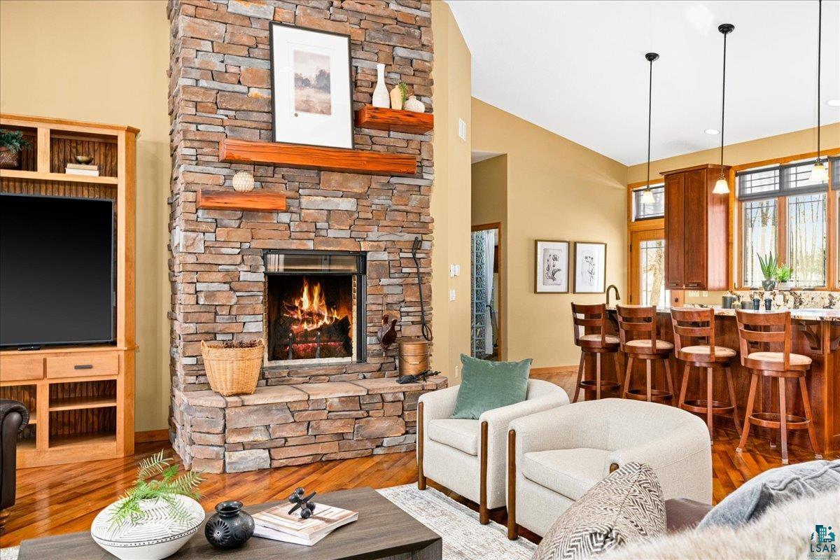 92598 Spells Road Sturgeon Lake, MN 55783 - Photo 7 of 60 Living room featuring wood finished floors, a fireplace, and vaulted ceiling