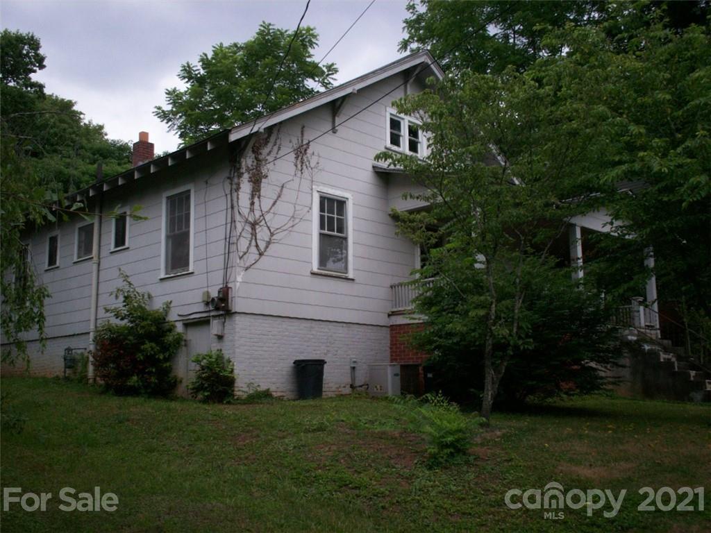412 South Main Street Southwest Lenoir, NC 28645 - Photo 3 of 10 a front view of a house with a garden