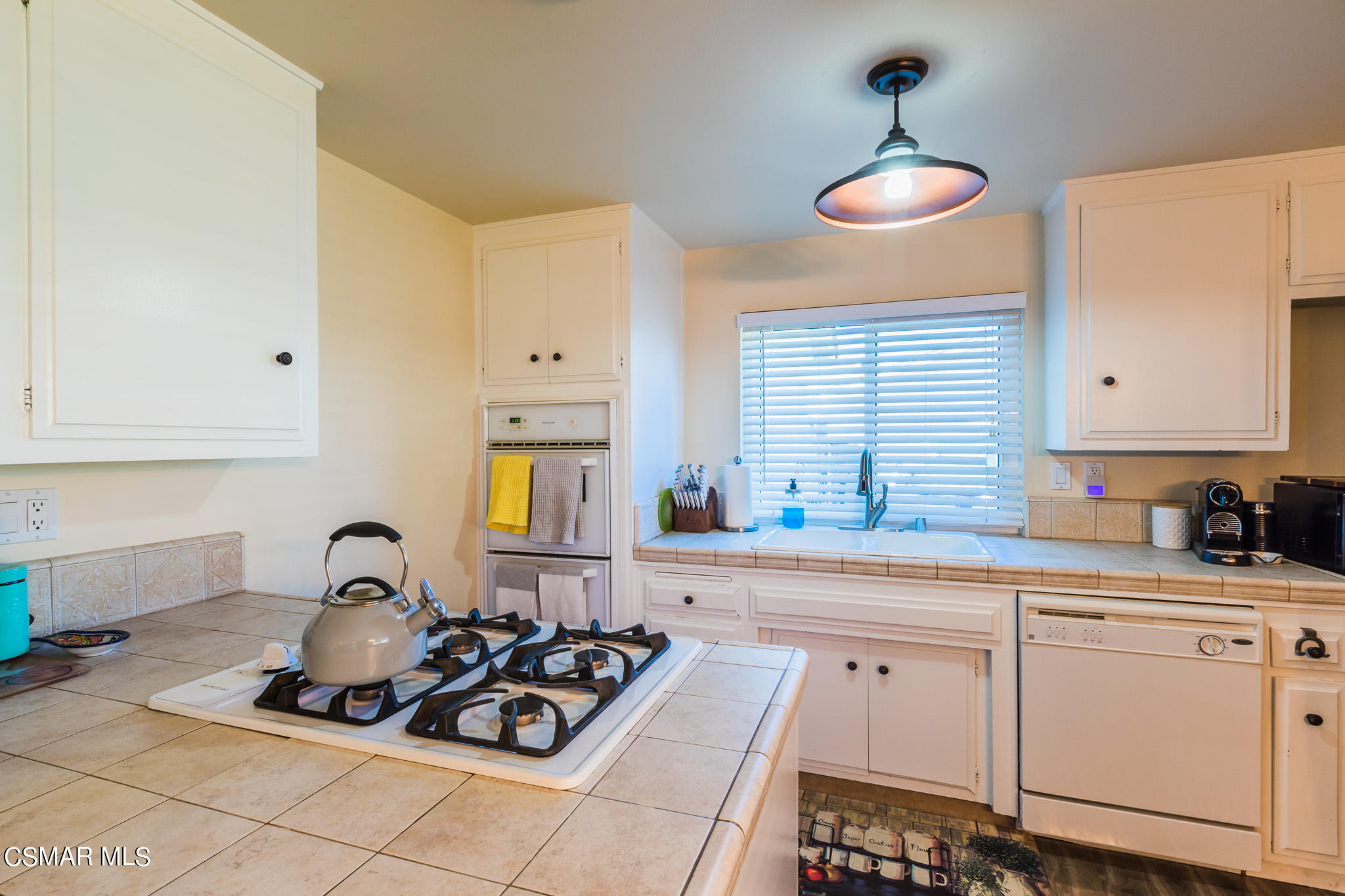 2149 Rhoda Street Simi Valley, CA 93065 - Photo 11 of 48 a kitchen with white cabinets and appliances