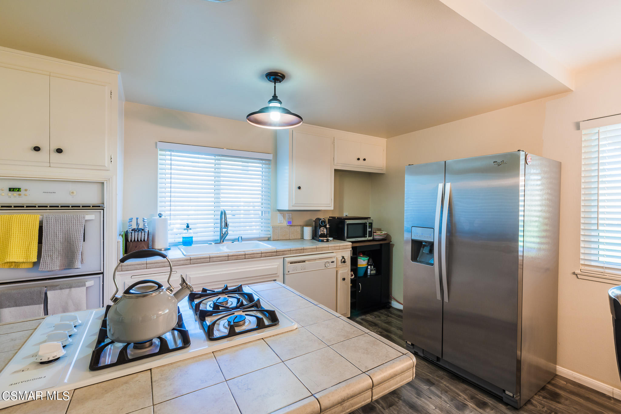 2149 Rhoda Street Simi Valley, CA 93065 - Photo 12 of 48 a kitchen with stainless steel appliances granite countertop a sink refrigerator and microwave