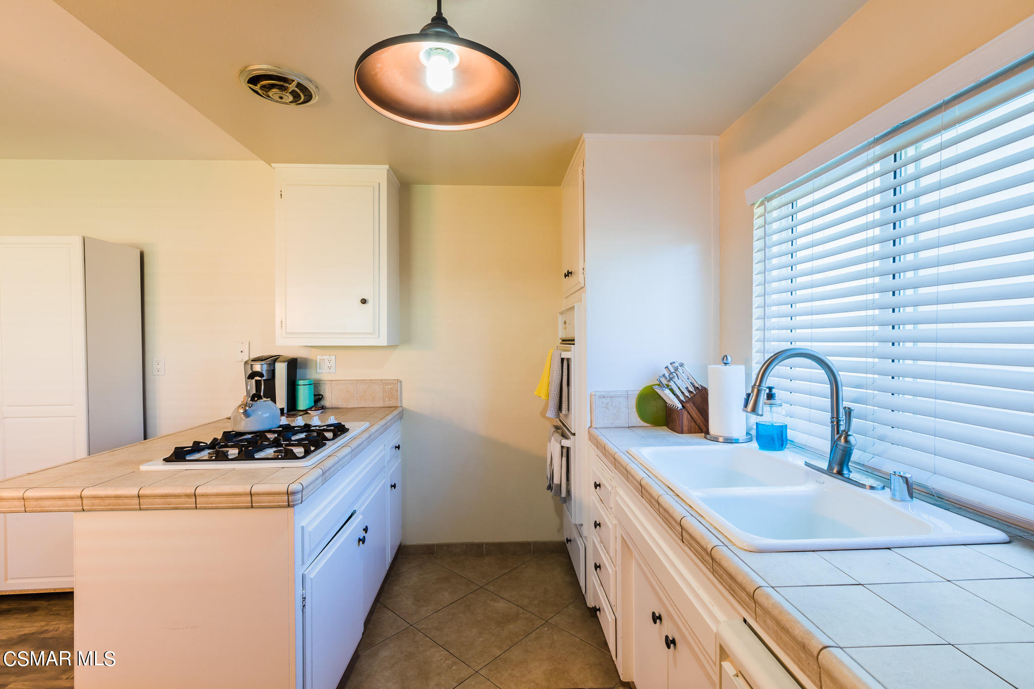 2149 Rhoda Street Simi Valley, CA 93065 - Photo 14 of 48 a kitchen with stainless steel appliances granite countertop a sink a stove and a refrigerator