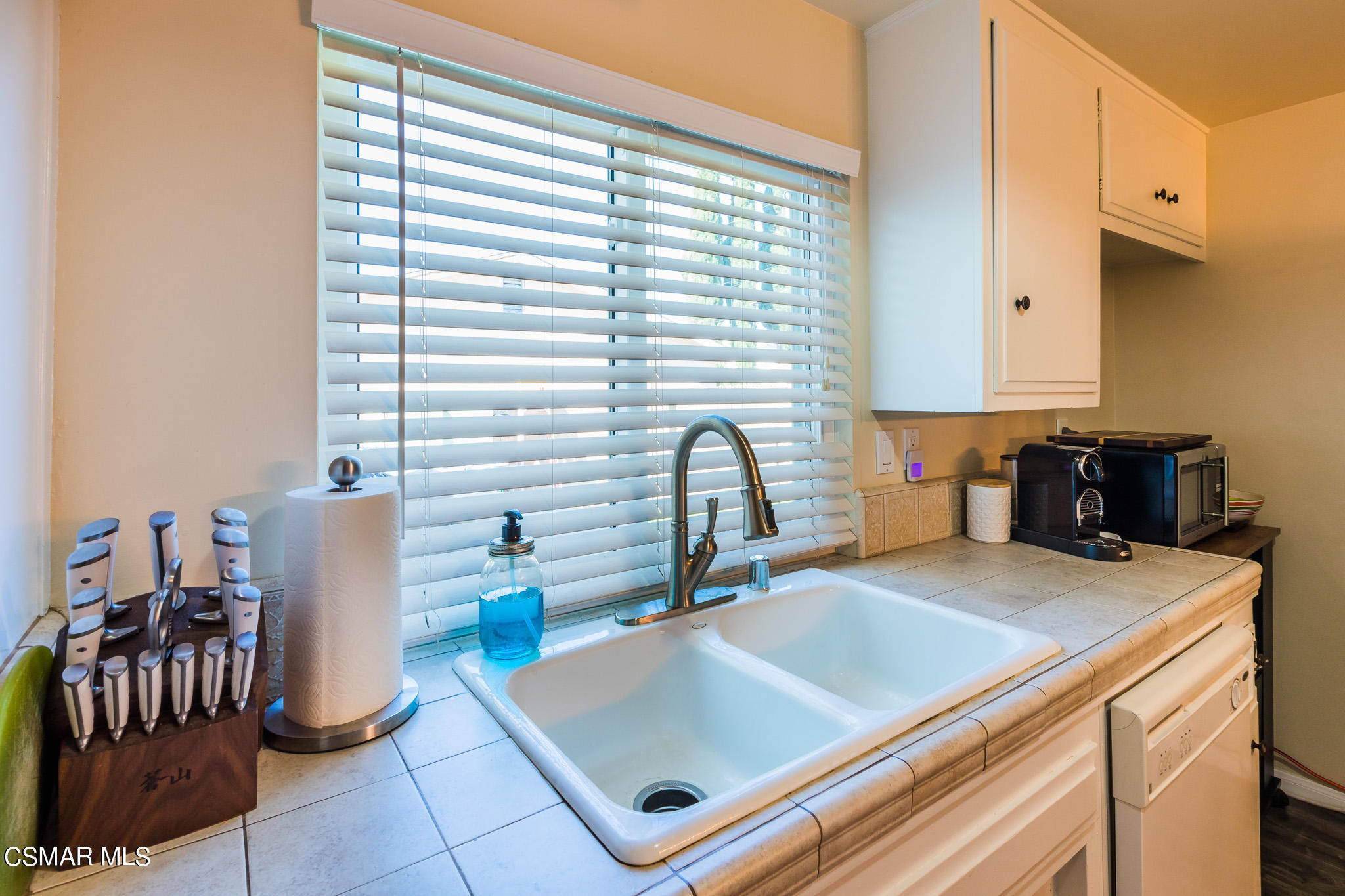 2149 Rhoda Street Simi Valley, CA 93065 - Photo 15 of 48 a kitchen with a stove a sink and a refrigerator