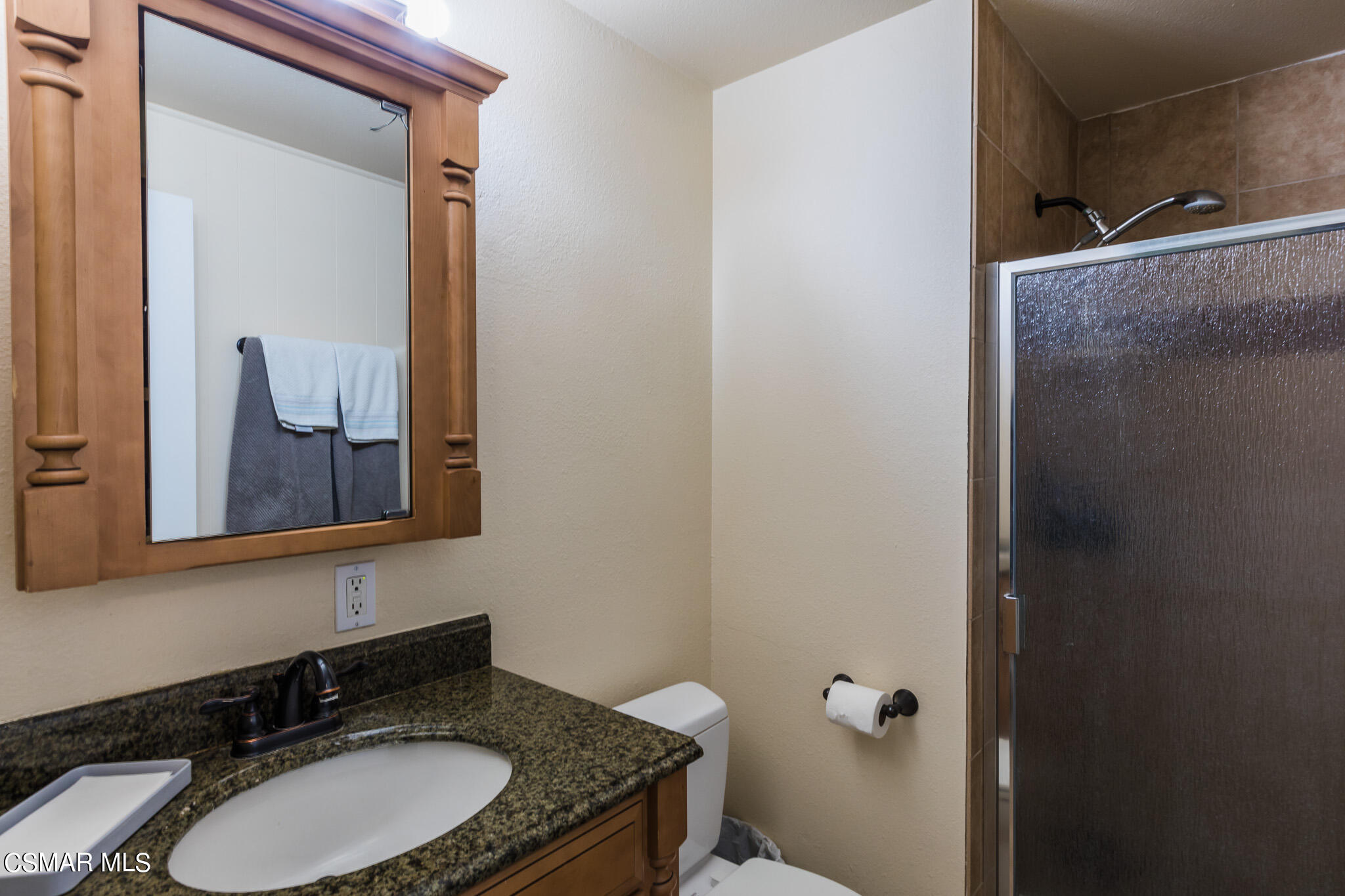 2149 Rhoda Street Simi Valley, CA 93065 - Photo 20 of 48 a bathroom with a granite countertop sink and mirror