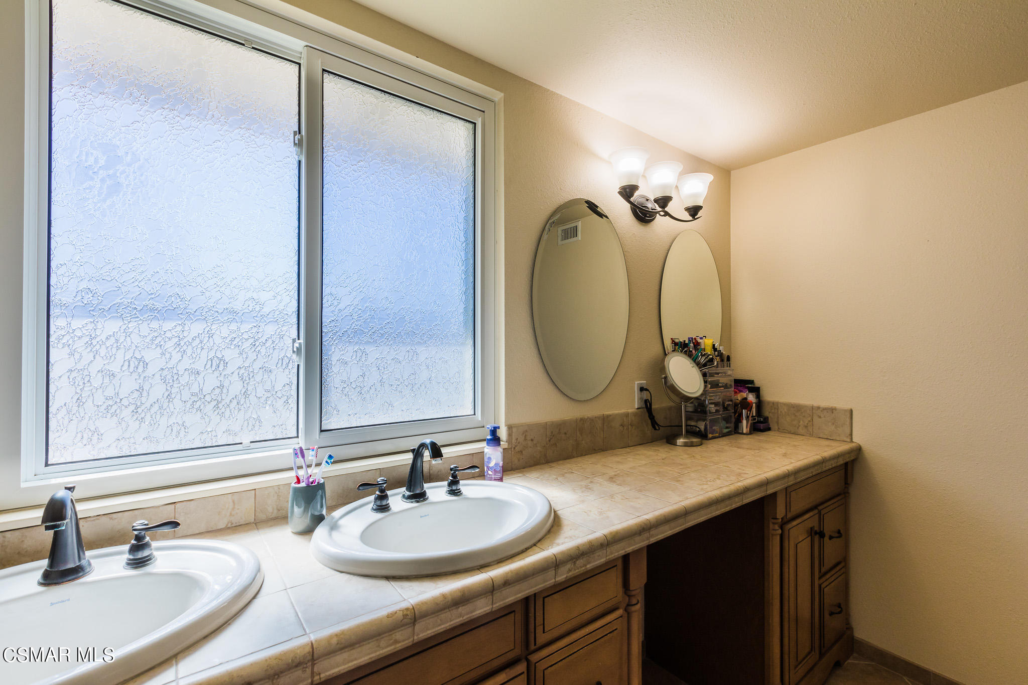 2149 Rhoda Street Simi Valley, CA 93065 - Photo 26 of 48 a bathroom with a double vanity sink and a mirror