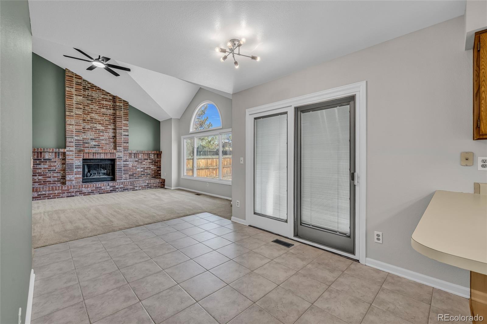 9390 Yale Lane Highlands Ranch, CO 80130 - Photo 24 of 50 an empty room with windows and fireplace