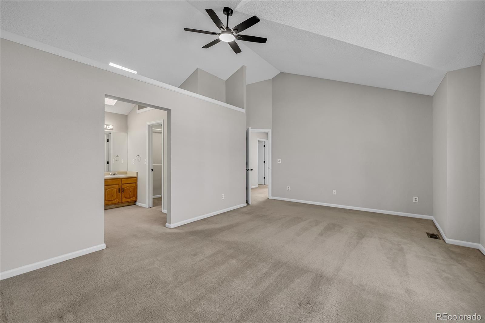 9390 Yale Lane Highlands Ranch, CO 80130 - Photo 27 of 50 a view of a livingroom with a projector & a ceiling fan