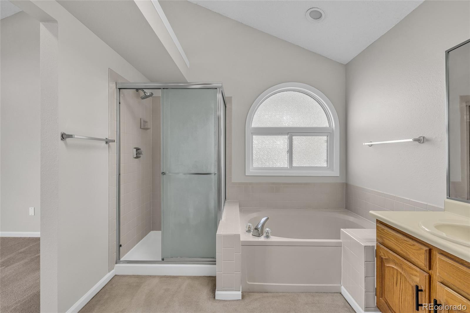 9390 Yale Lane Highlands Ranch, CO 80130 - Photo 29 of 50 a bathroom with a tub shower and sink