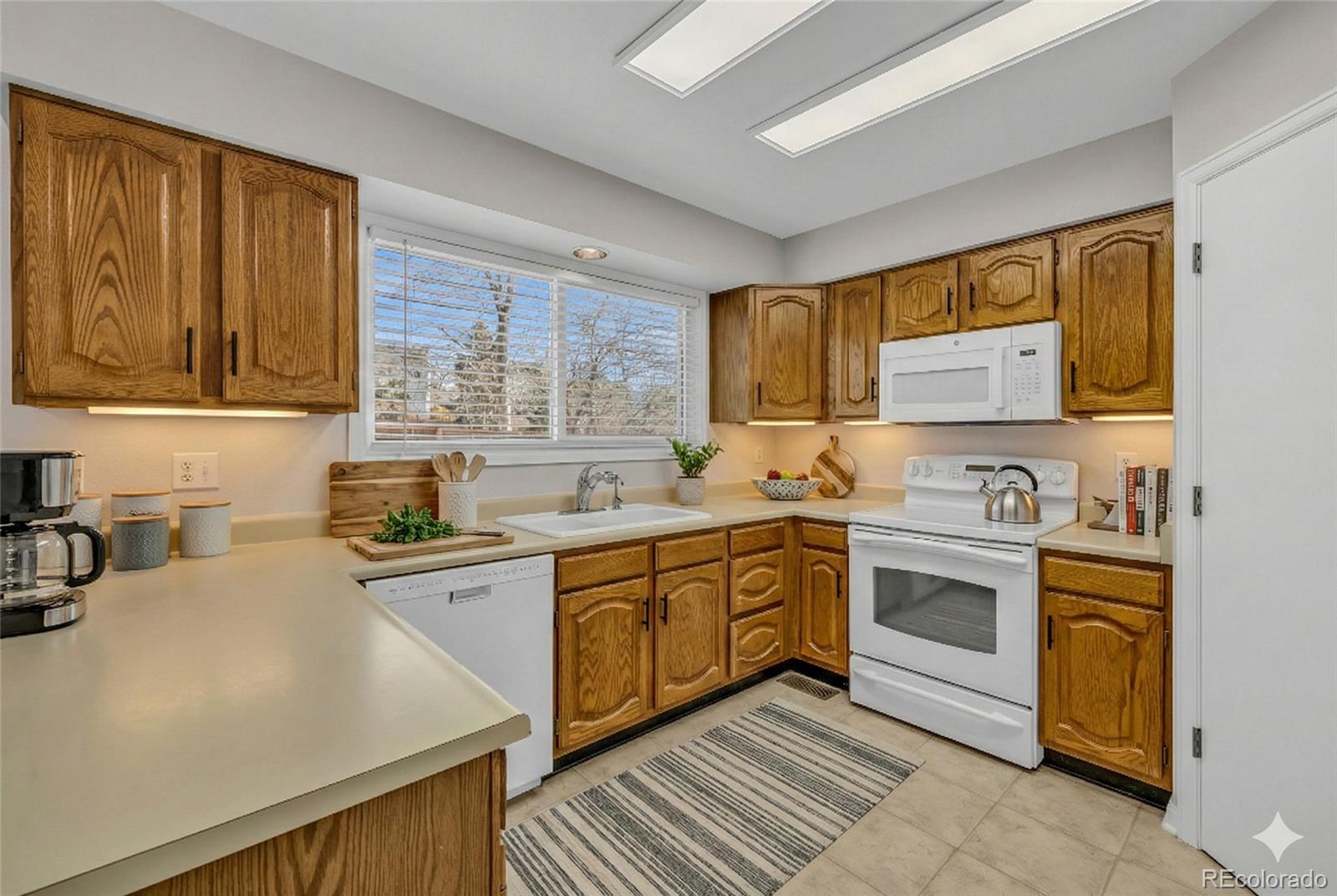 9390 Yale Lane Highlands Ranch, CO 80130 - Photo 6 of 50 a kitchen with a stove sink and cabinets