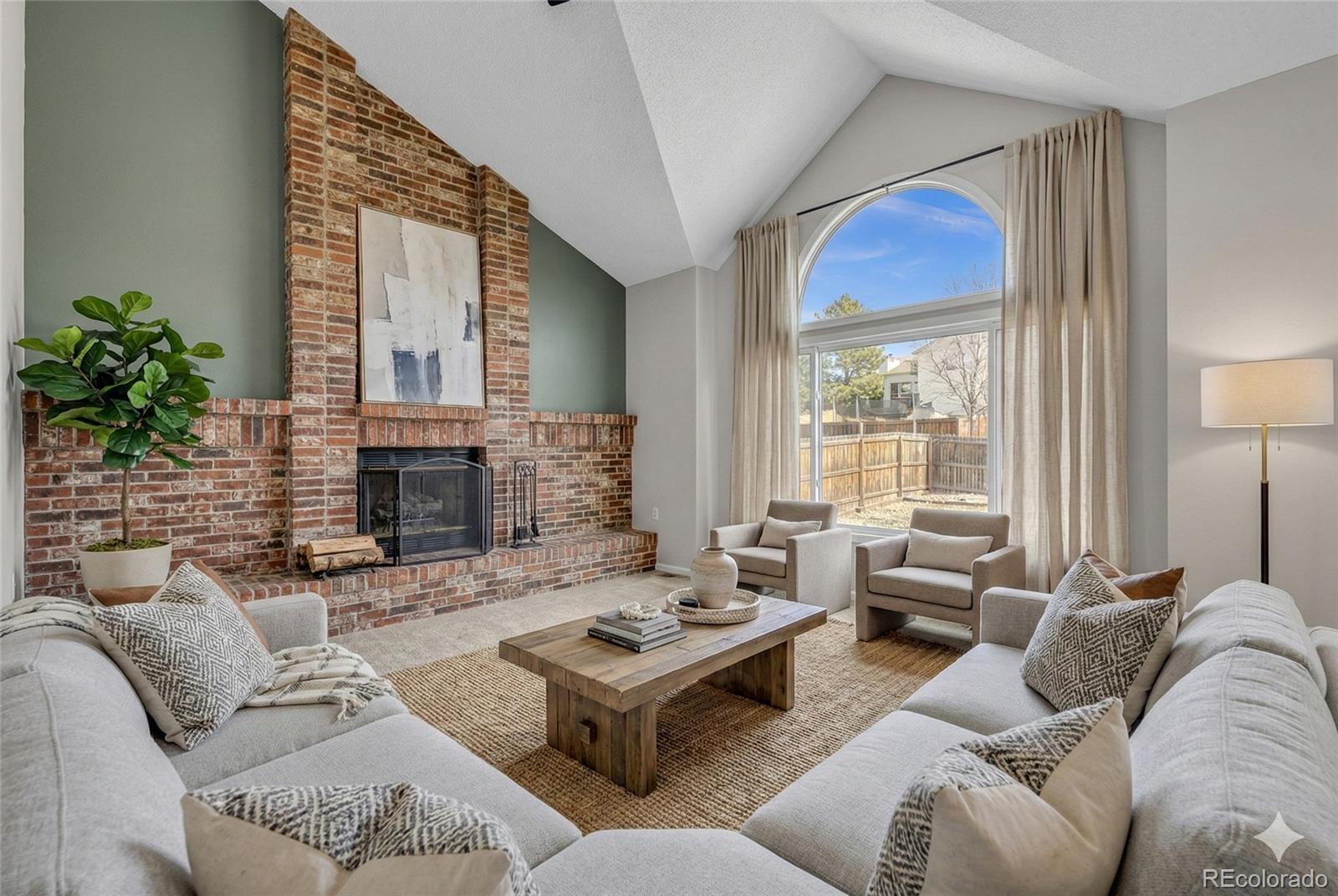 9390 Yale Lane Highlands Ranch, CO 80130 - Photo 7 of 50 a living room with furniture and a fireplace