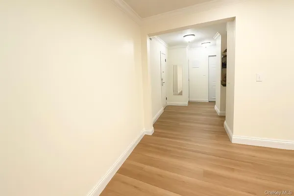 a view of a hallway with wooden floor