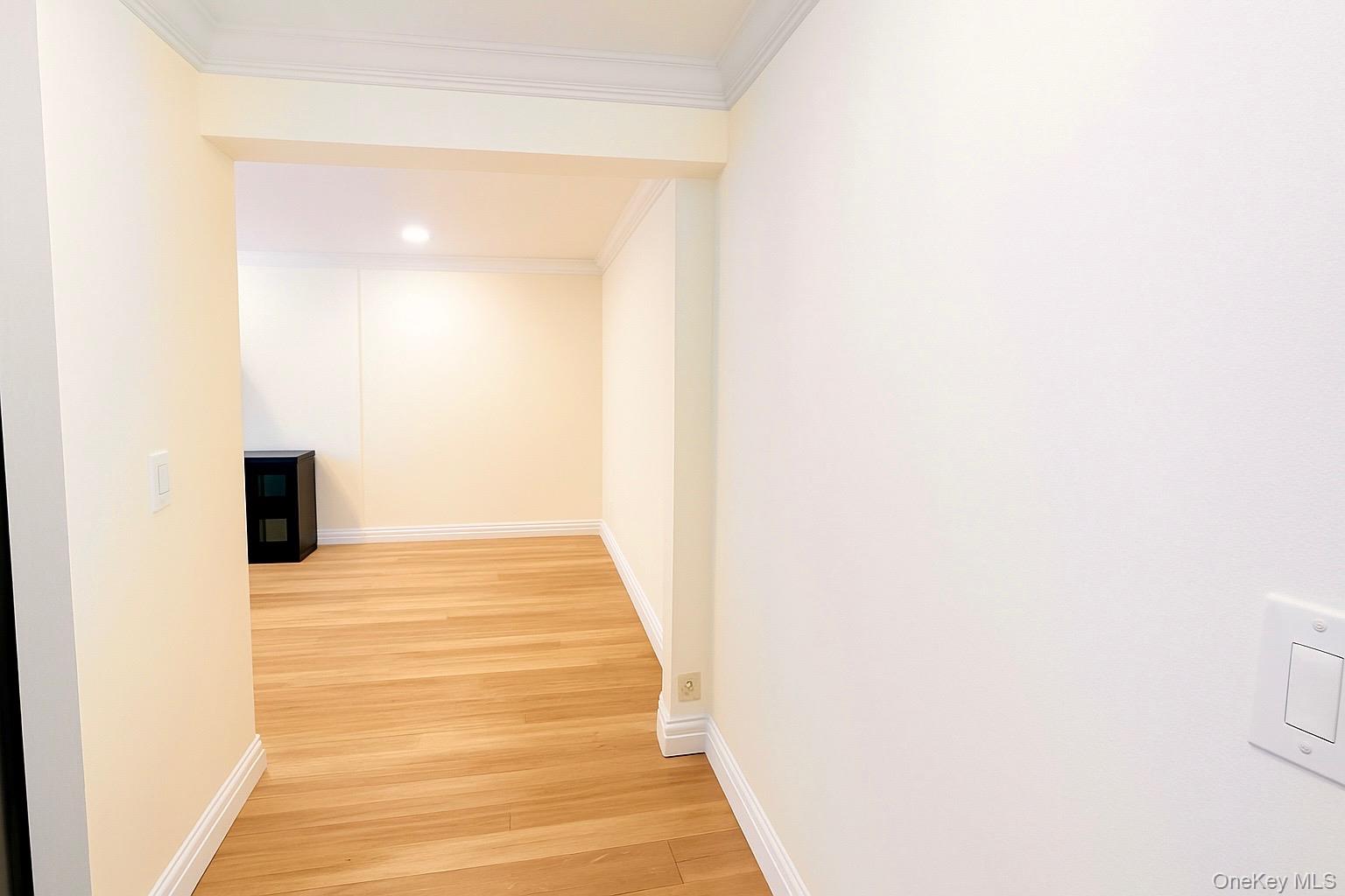 60 White Oak Street, Unit 2H New Rochelle, NY 10801 - Photo 6 of 15 a view of a hallway with wooden floor