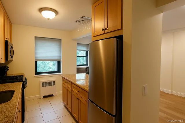 a kitchen with stainless steel appliances granite countertop a refrigerator and a sink